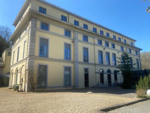 a large white building with a lot of windows at Castel de Pont-a-Lesse in Dinant