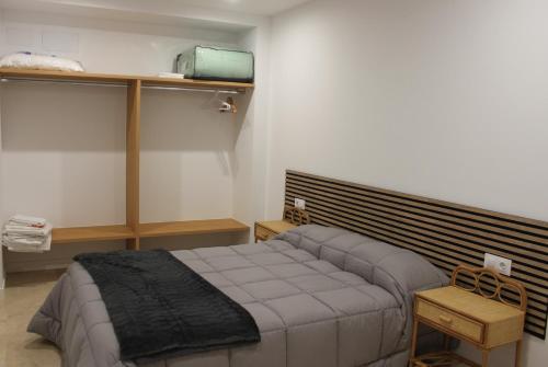 a bedroom with a bed in a room at XELIÑA c in A Estrada