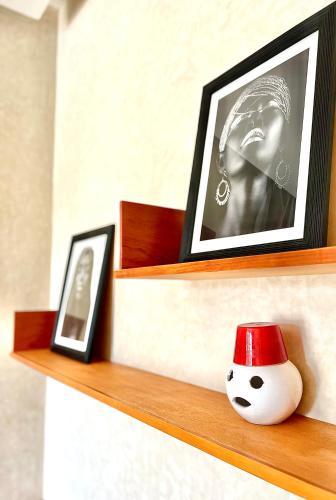 a shelf with a picture and a doll on it at Villa Jardins D'Isa in Marrakech
