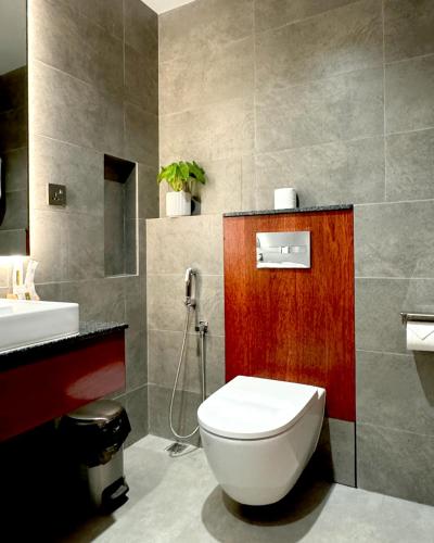 a bathroom with a toilet and a sink at Baa Sand Maldives in Kudarikilu