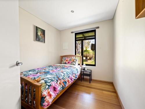 a bedroom with a bed and a window at La Casa Gracie, Balga Sanctuary in Margaret River in Gracetown