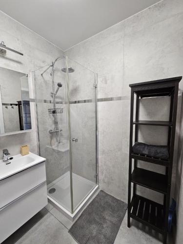 a bathroom with a shower with a sink and a shower at PB EasyStay in Szczytno