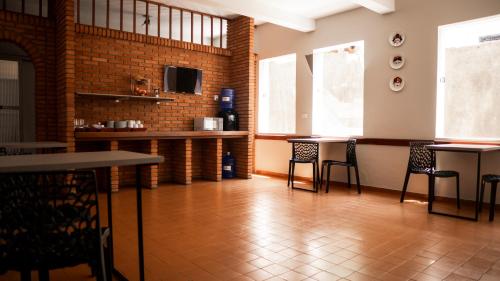 a dining room with tables and chairs and a television at Smart Hotel in Guaxupé