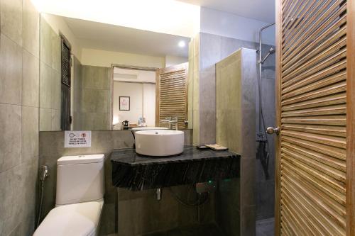 a bathroom with a sink and a toilet at JALMIN Hotel Samui in Chaweng