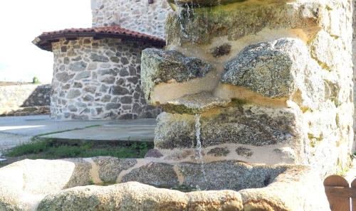 a water fountain in front of a building at Apartamentos Muralla Sacra in Sober