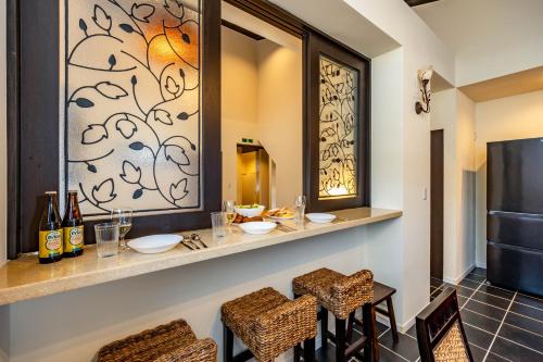 a bar in a room with two tables and chairs at 1688House美ら海 in Motobu