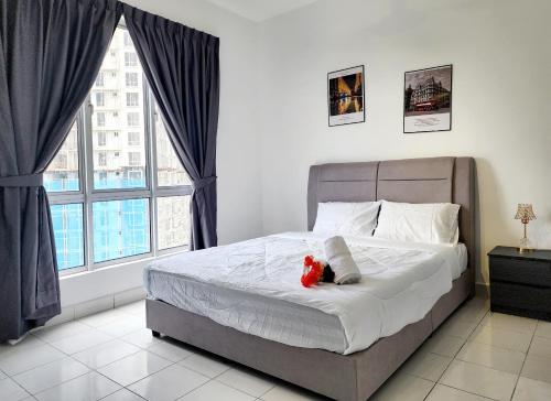 a bedroom with a bed with a teddy bear on it at Malacca Spacious 3Bedroom Wifi Carpark in Malacca