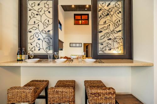 a dining room with a bar with two stools at 1688House美ら海 in Motobu