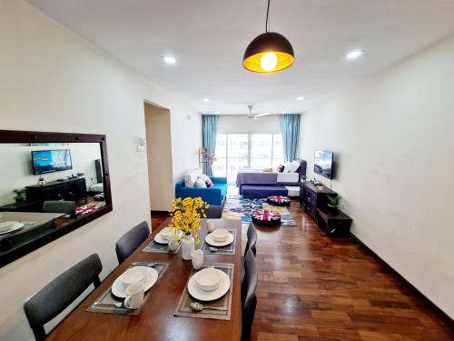 a living room with a dining table and a couch at 9 Guest 3 Room Koi Endless Pool BBQ Sunway Lagoon Pyramid IOI Puchong Bkt Jalil Pavillion Bkt Jalil Stadium in Puchong