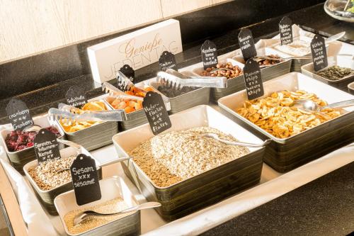 a buffet filled with different types of food in trays at Best Western Hotel München Airport in Erding