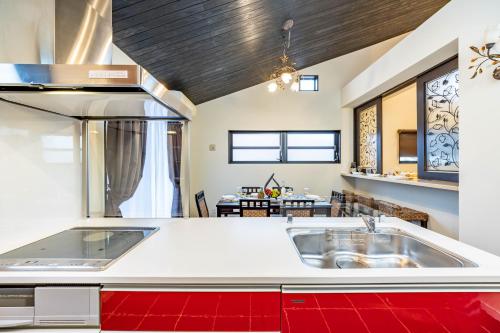 a kitchen with a large tub and a dining room at 1688House美ら海 in Motobu