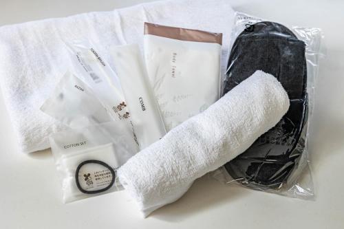 a roll of toilet paper and other items on a table at 1688House美ら海 in Motobu