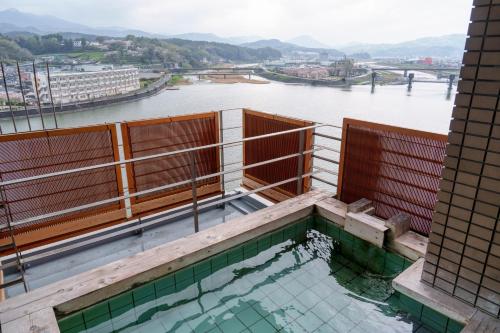 a building with a view of a river at Hita Onsen Kizantei Hotel in Hita