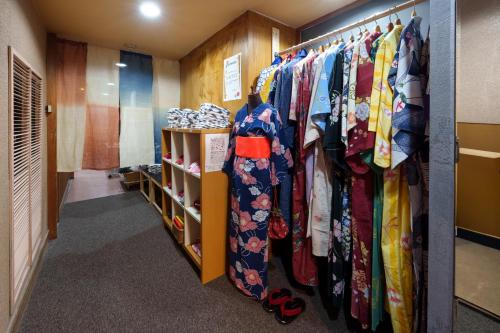 a dressing room with a rack of clothes at Hita Onsen Kizantei Hotel in Hita