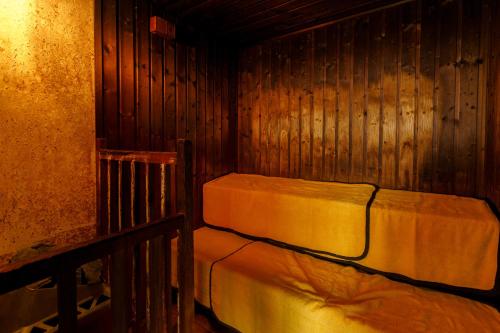 a room with two beds in a wooden cabin at Hita Onsen Kizantei Hotel in Hita