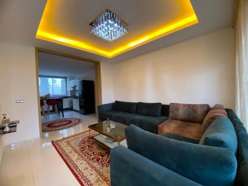 a living room with a couch and a table at Appart en bord de mer avec piscine vue imprenable in Aourir