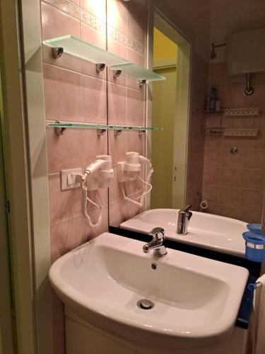 a bathroom with a sink and a mirror at Appartamento Luigi in Alba Adriatica