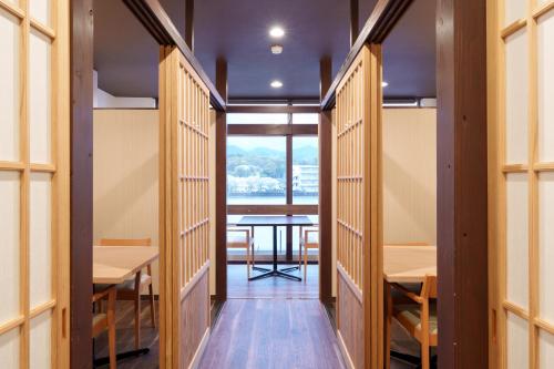 a corridor of a room with a table and a window at Hita Onsen Kizantei Hotel in Hita