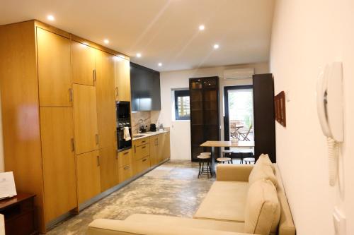 a living room with a couch and a kitchen at Francos Family House in Porto