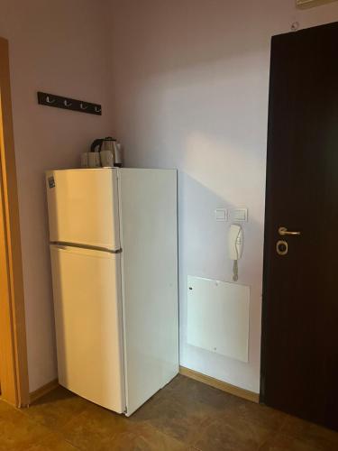 a white refrigerator in a room with a phone at BLOCK 531 ApartHouse BLOCK 533 in Sofia