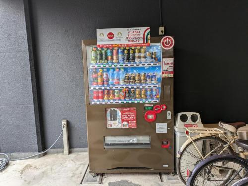 a vending machine filled with lots of bottles of soda at Hita Onsen Kizantei Hotel in Hita