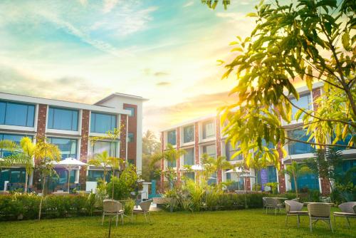 an exterior rendering of a building with chairs in a yard at Elements by Rosetta- Varca, Goa in Varca