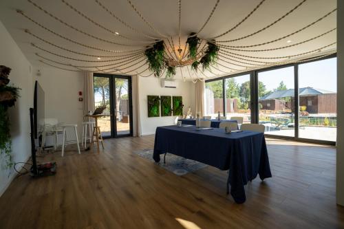 a large room with a table with a blue table cloth at Refúgio da Quinta Nere Maitia in Santarém