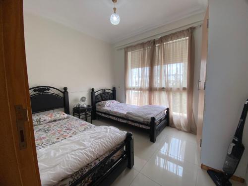 Postel nebo postele na pokoji v ubytování Confort et Vue Mer Appartement avec Piscine