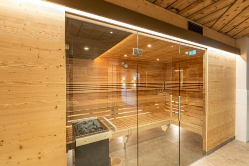 a sauna in a building with a wooden wall at Ferienhotel Gasthof zur Post in Untertauern