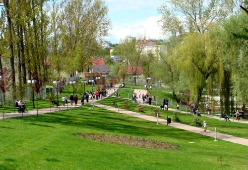 a group of people walking in a park at Hugo's Apartment in Suceava