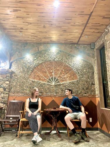 a man and a woman sitting at a table at Sầm Sơn Boutique Hotel Phan Thiết in Phan Thiet