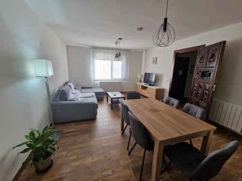a living room with a table and a couch at Las Natillas con V in Martín Miguel