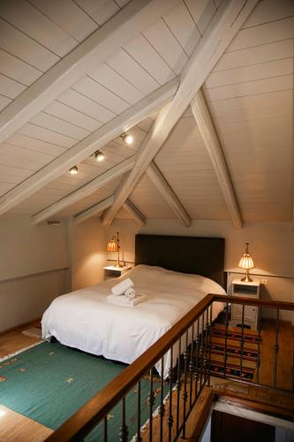a bedroom with a large bed in a attic at Guest House Ioanna Arachova in Arachova