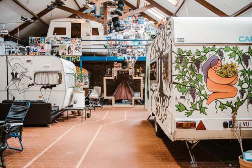 a food truck parked in a garage with a woman painted on it at Treck Hostel in Ghent