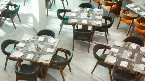 a group of tables and chairs in a restaurant at Elements by Rosetta- Varca, Goa in Varca