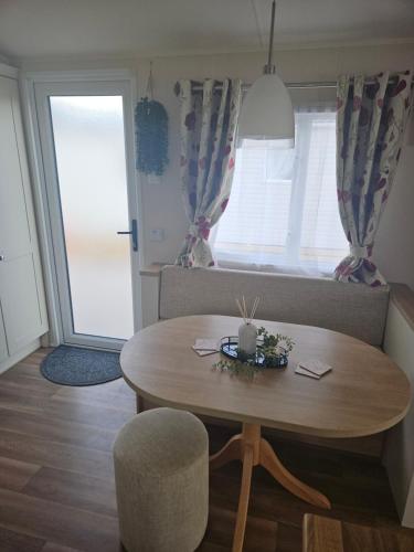 a living room with a table and a couch at Lytham Luxe 6 Birth Caravan in Weeton