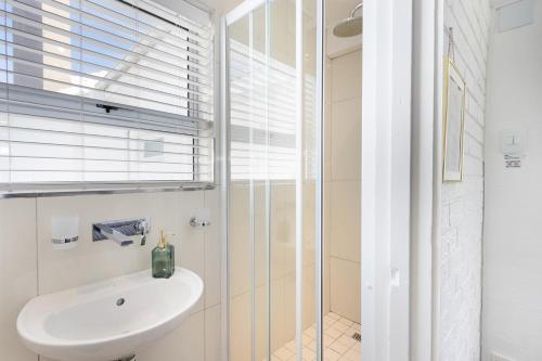 a bathroom with a sink and a shower at Sea View Hilltop Villa, Blouberg in Cape Town