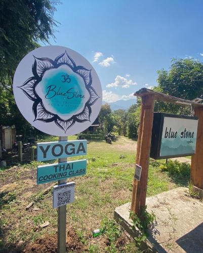a sign for a yogaarmaarma coaching clinic at Blue stone in Pai