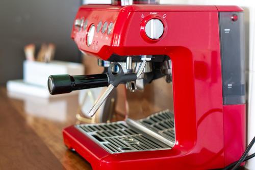 a red sewing machine sitting on top of a table at Lakefront House - INEA Retreat in Karraganbah