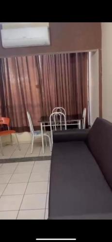 a living room with a couch and a table and chairs at thermasparadise Rio quente in Rio Quente