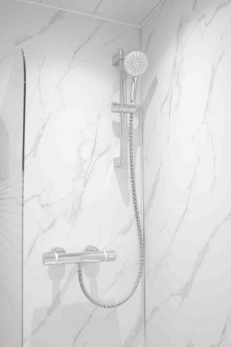 a shower with a shower head in a bathroom at Granby House in Livingston