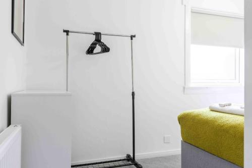 a floor lamp in a white room with a bed at Granby House in Livingston