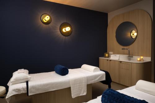 a bathroom with two beds and a sink at Hyatt Place Rouen in Rouen
