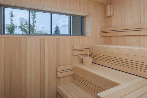 a sauna with wooden benches and a window at Hyatt Place Rouen in Rouen