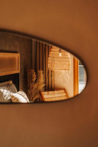 a reflection of a lamp in a mirror at Apartament Riders Lodge Sopot in Sopot