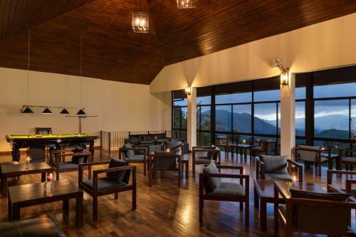 a restaurant with tables and chairs and a pool table at Simpson's Forest - Luxury Boutique Resort & Spa - Kandy in Kandy