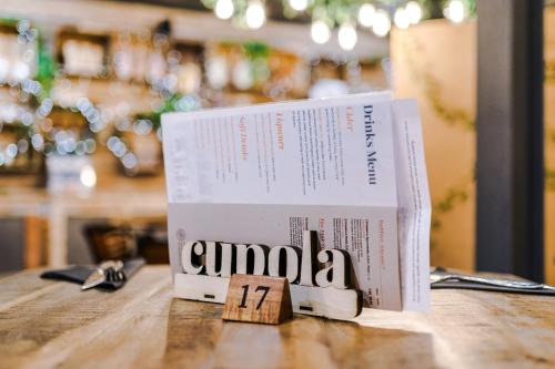 two books sitting on top of a table at Rock Mill - Deluxe Studio Apartments in Stoney Middleton