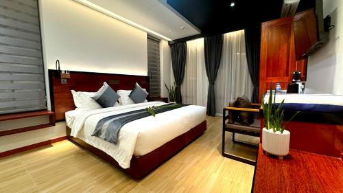 a bedroom with a large bed and a sink at Baa Sand Maldives in Kudarikilu