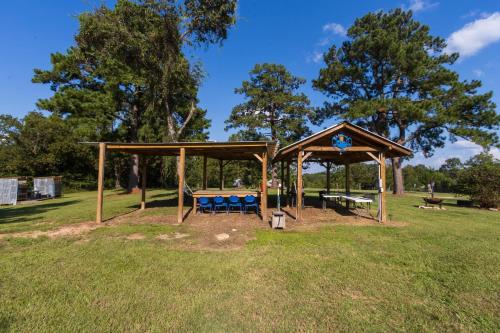 a gazebo with a picnic table in a park at Khushatta Hills Ranch Glamping - Mom Mollie in Coldspring