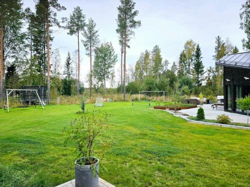 a large green field with a soccer goal at Egen del av modern villa i Kåge in Skellefteå